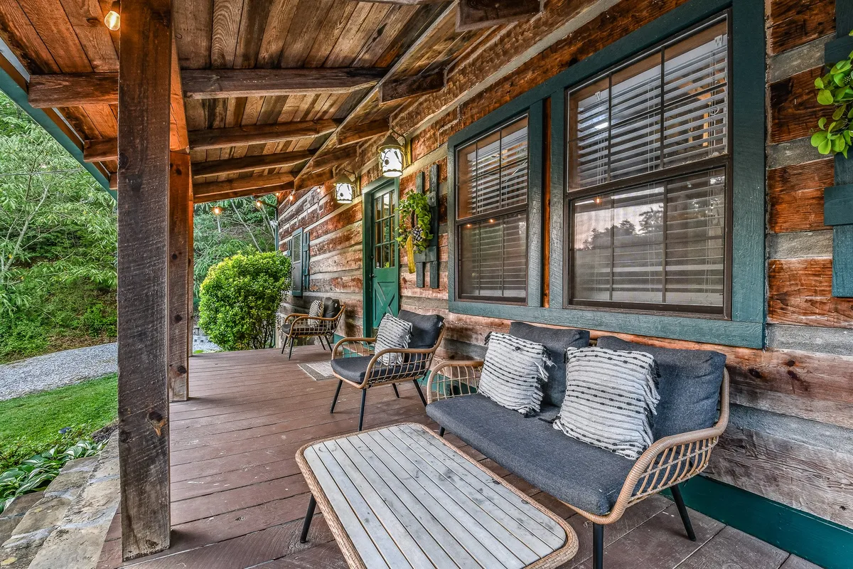 An exterior deck featuring comfortable wooden seating and views of lush greenery—perfect for enjoying fresh mountain air, outdoor dining, or relaxing after a meal.